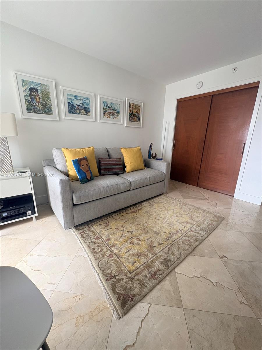 151 Southeast 15th Road, Unit 601 Miami, FL 33129 - Photo 29 of 36 a living room with furniture and a couch