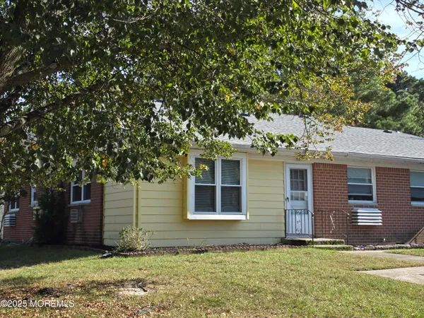 a house that has a tree in front of it