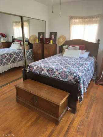 a bed sitting in a bedroom next to a window