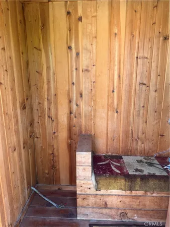 a view of a porch with a table and chairs