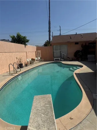 a view of a house with porch and a sitting area
