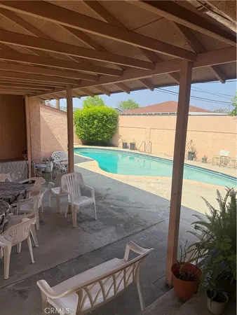 a view of a porch with furniture and floor to ceiling window
