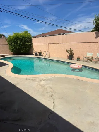 a view of a house with backyard and sitting area