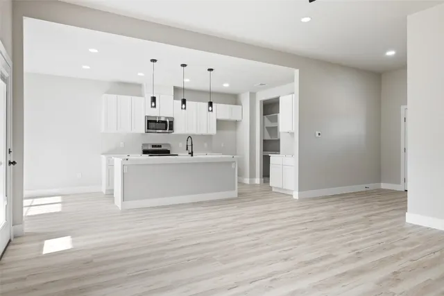 a view of kitchen with cabinets and wooden floor