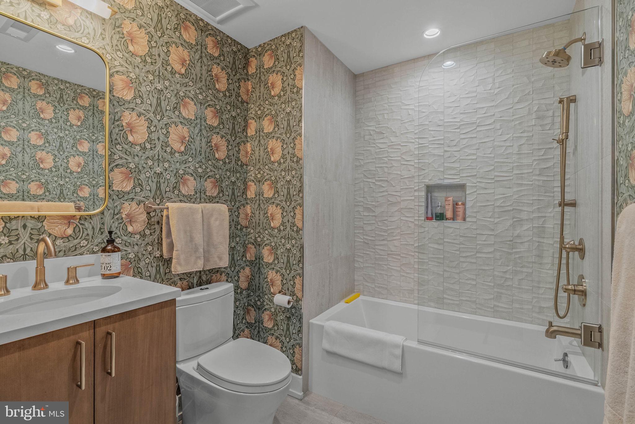 262 South 16th Street, Unit 4 Philadelphia, PA 19102 - Photo 13 of 30 a bathroom with a granite countertop bathtub shower sink vanity and toilet
