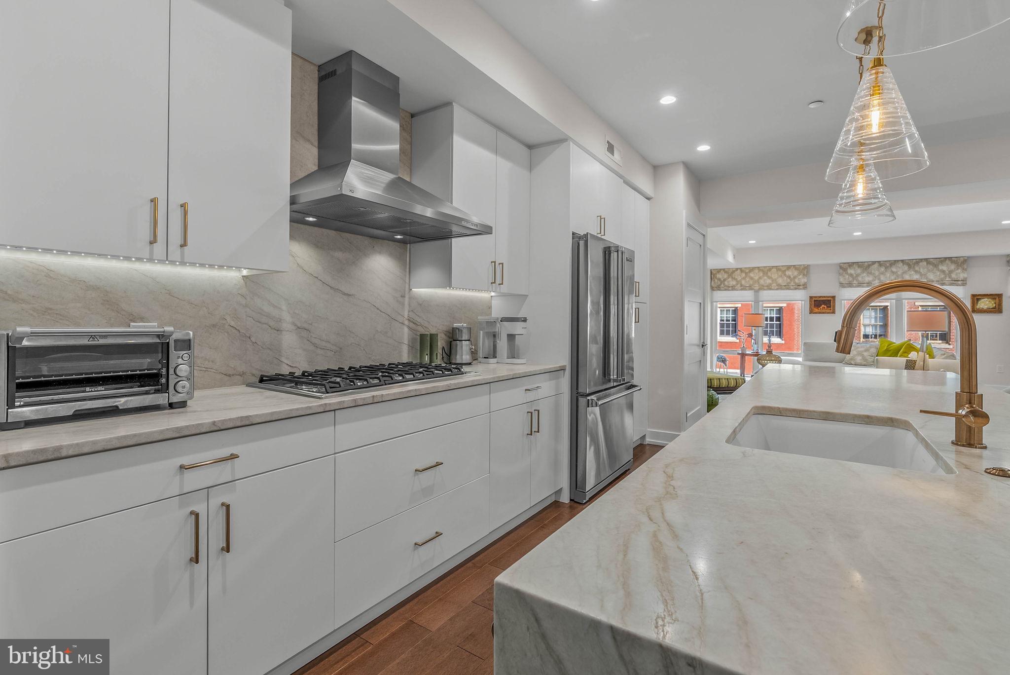 262 South 16th Street, Unit 4 Philadelphia, PA 19102 - Photo 22 of 30 a kitchen with stainless steel appliances granite countertop a sink a stove and a refrigerator
