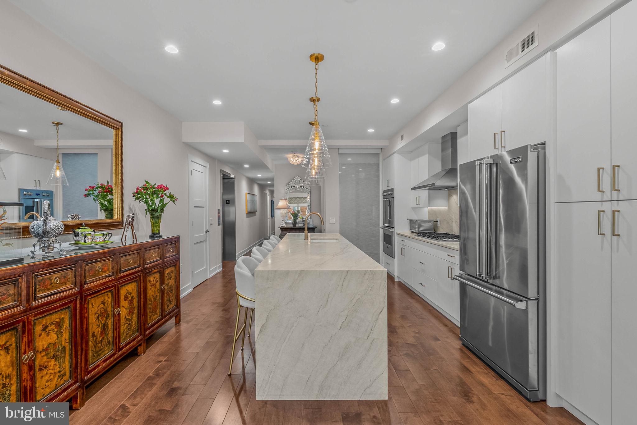 262 South 16th Street, Unit 4 Philadelphia, PA 19102 - Photo 25 of 30 a kitchen with stainless steel appliances granite countertop a refrigerator a stove and a sink