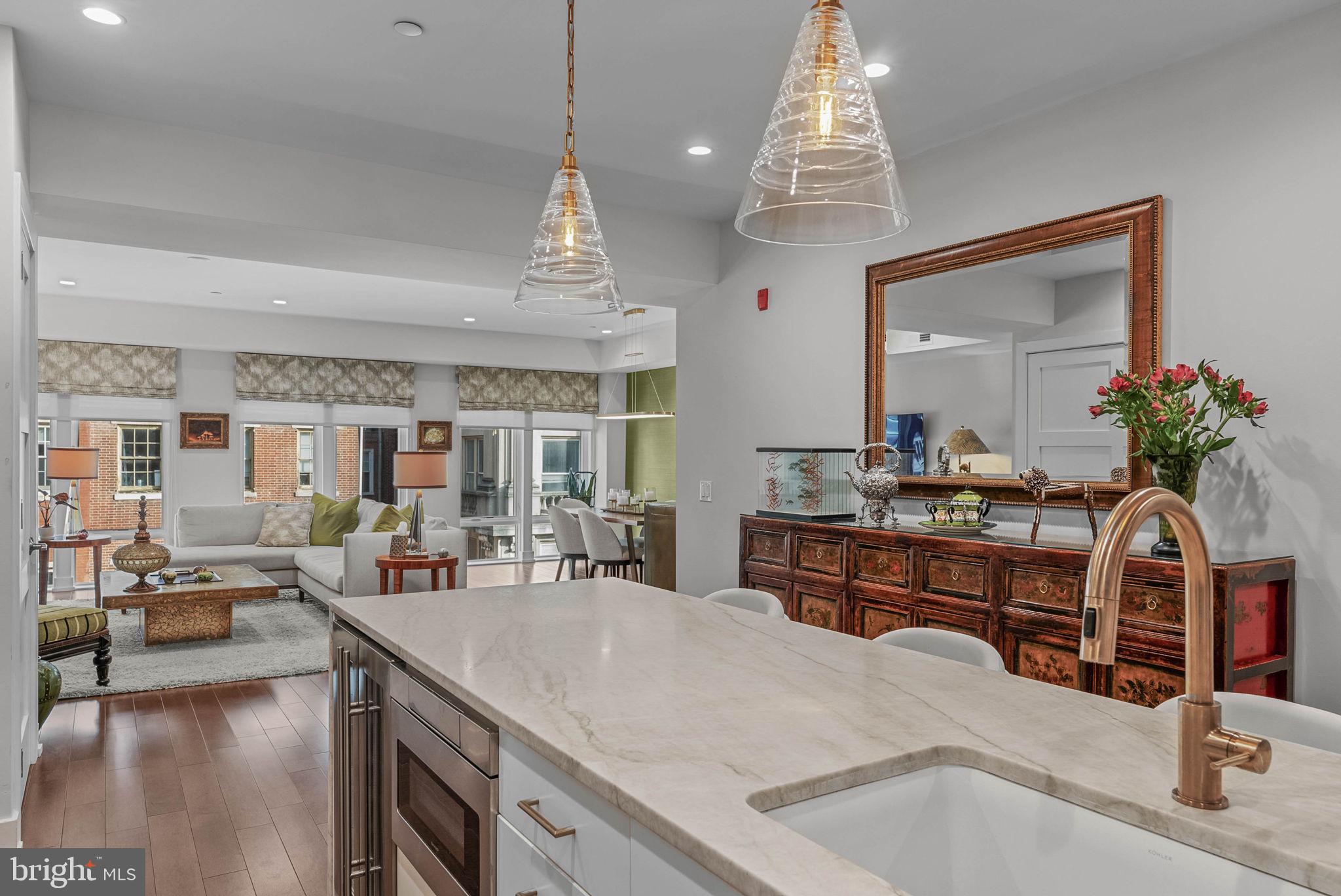 262 South 16th Street, Unit 4 Philadelphia, PA 19102 - Photo 27 of 30 a living room with kitchen island furniture and a chandelier