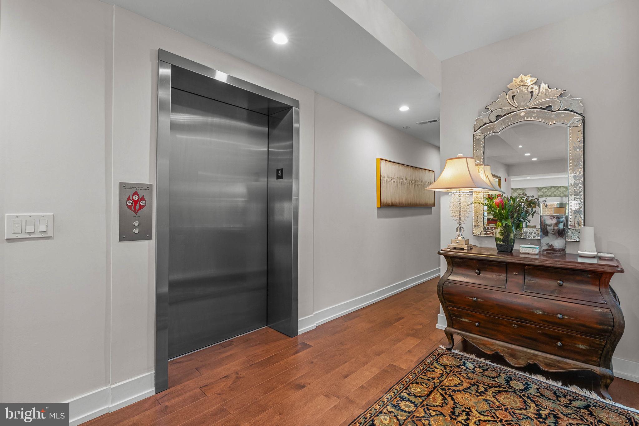 262 South 16th Street, Unit 4 Philadelphia, PA 19102 - Photo 4 of 30 a room with wooden floor and a chandelier