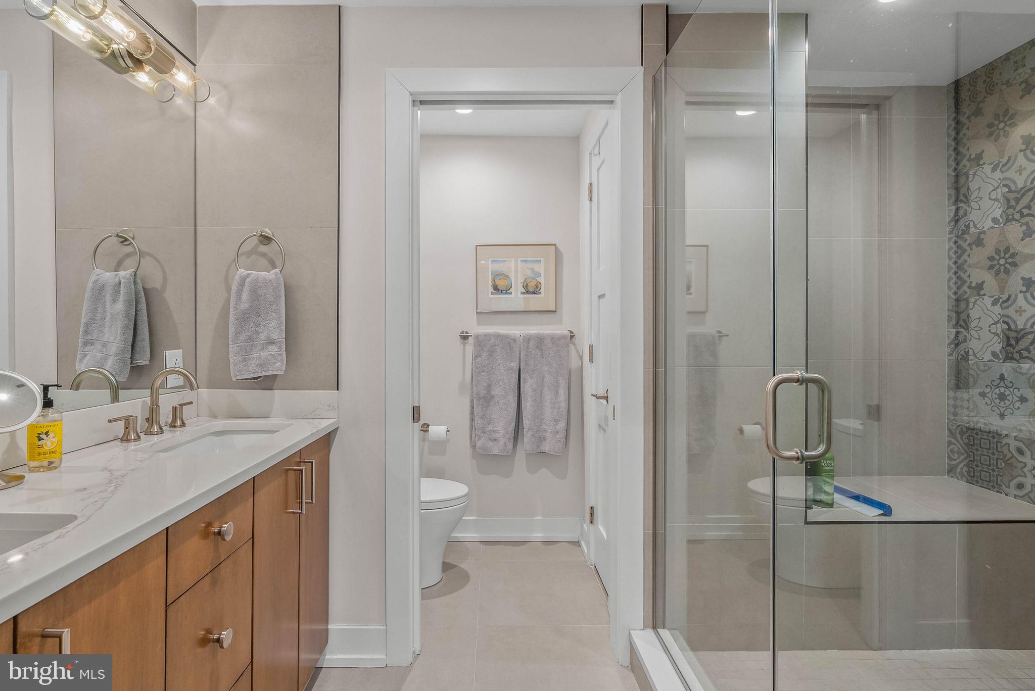 262 South 16th Street, Unit 4 Philadelphia, PA 19102 - Photo 5 of 30 a bathroom with a granite countertop sink mirror and double