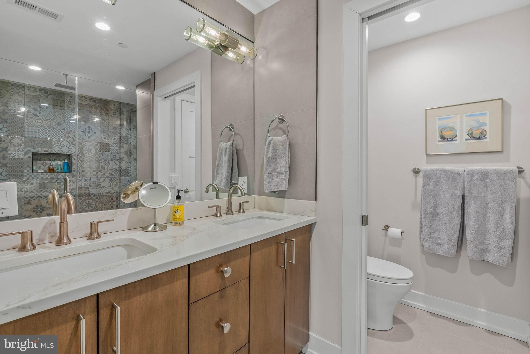 262 South 16th Street, Unit 4 Philadelphia, PA 19102 - Photo 7 of 30 a bathroom with a granite countertop sink toilet and shower