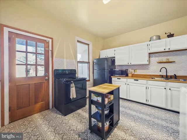 a kitchen with stainless steel appliances granite countertop a refrigerator sink and cabinets
