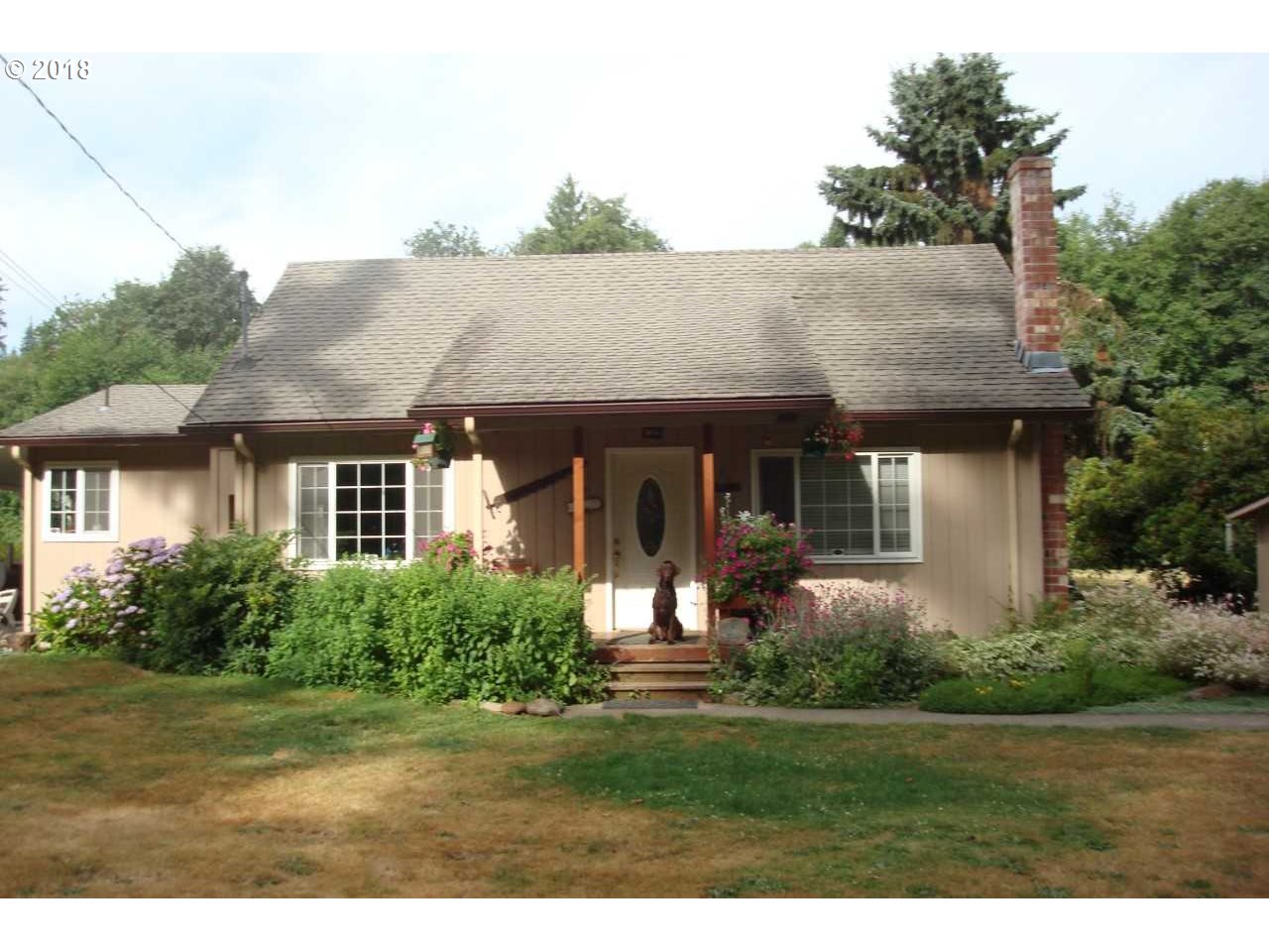 a front view of a house with a yard and porch