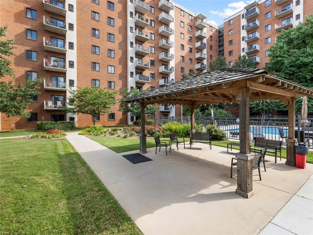 a view of a building with a garden and sitting area