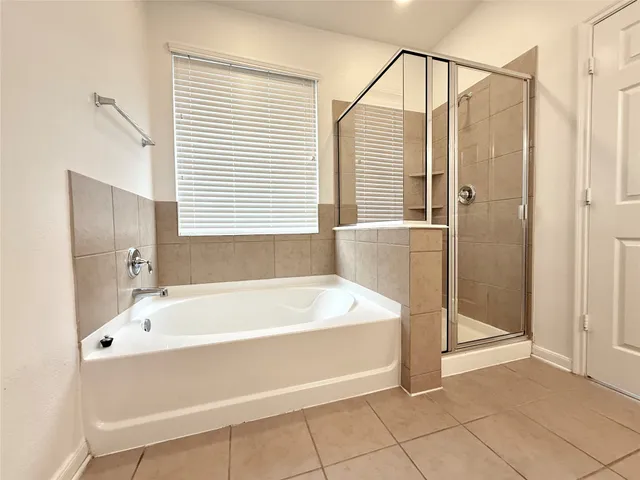 a bathroom with a tub and a shower