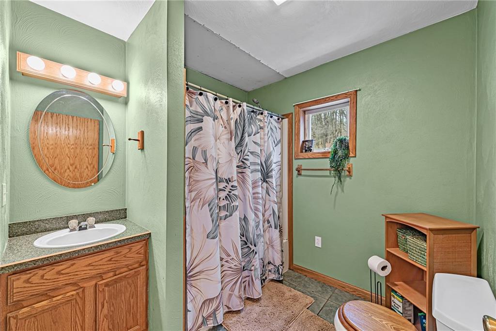 90 Montgomery Church Road Hillsdale, PA 15746 - Photo 11 of 25 a bathroom with a sink mirror toilet and shower
