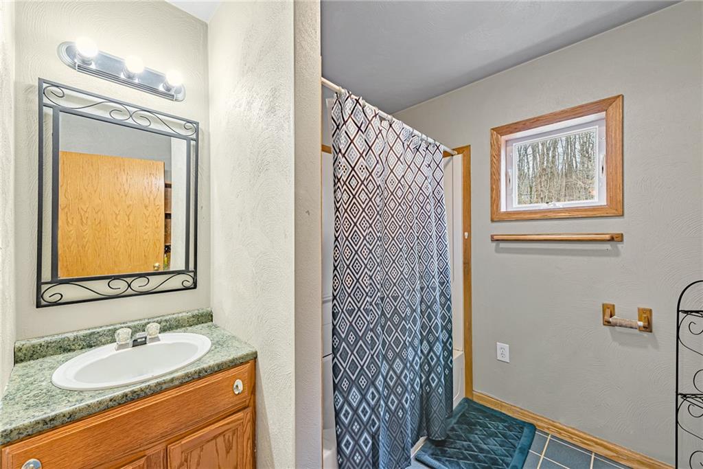 90 Montgomery Church Road Hillsdale, PA 15746 - Photo 17 of 25 a bathroom with a granite countertop sink and a mirror