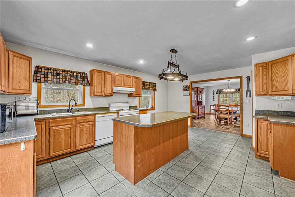 90 Montgomery Church Road Hillsdale, PA 15746 - Photo 9 of 25 a kitchen with stainless steel appliances granite countertop a stove and a sink
