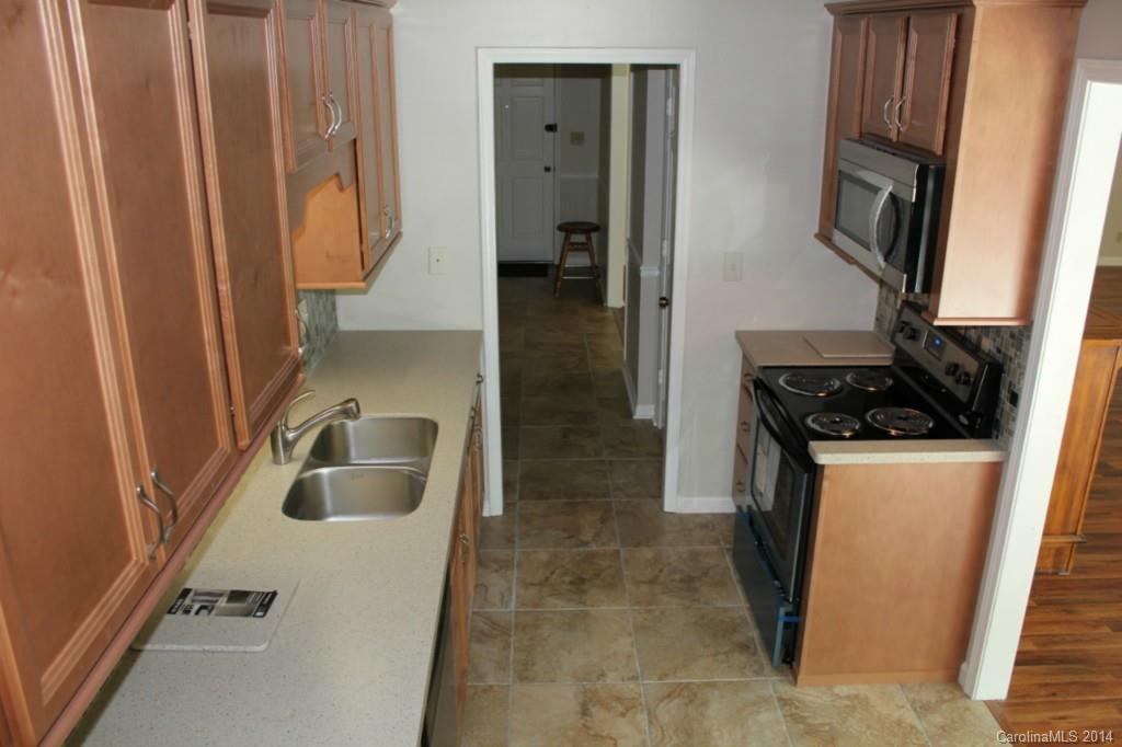 3590 Lake Shore Road South Denver, NC 28037 - Photo 14 of 18 a kitchen with sink refrigerator and stove