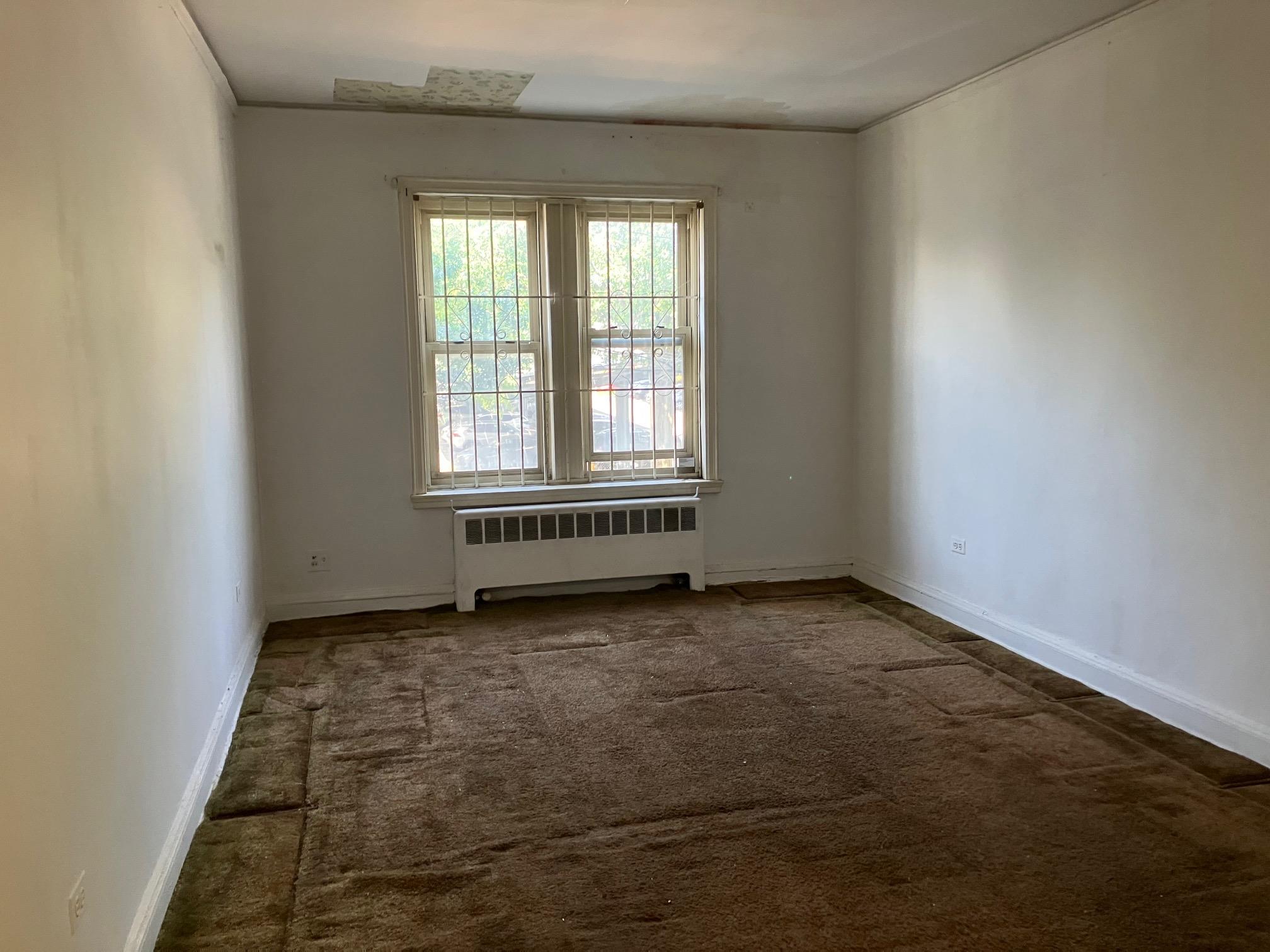 48-55 43rd Street, Unit 2F Queens, NY 11377 - Photo 2 of 13 an empty room with a window