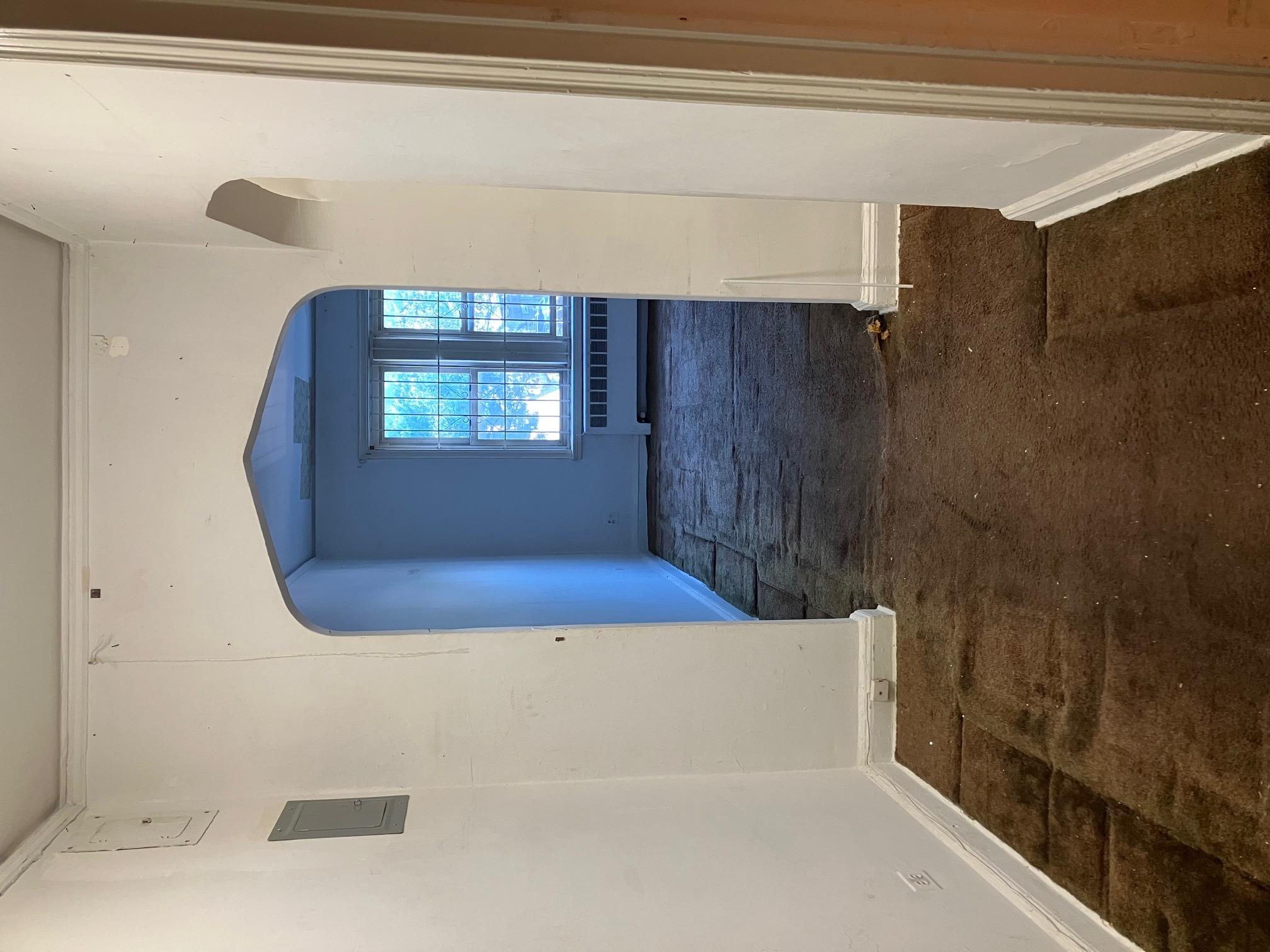 48-55 43rd Street, Unit 2F Queens, NY 11377 - Photo 5 of 13 a view of a hallway with wooden floor and a window