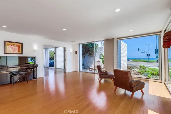 a kitchen with stainless steel appliances granite countertop a refrigerator a sink dishwasher a stove and white countertops with wooden floor