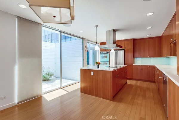 a kitchen with stainless steel appliances wooden cabinets a sink and a stove