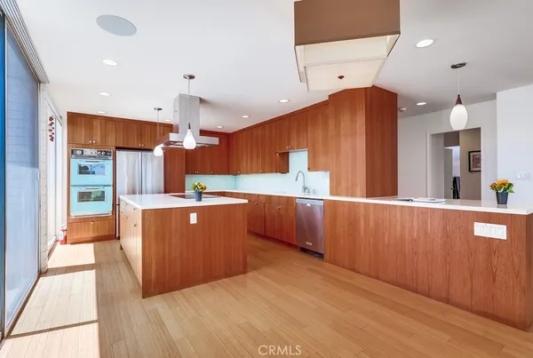 a kitchen with a cabinets a counter space cabinets and stainless steel appliances