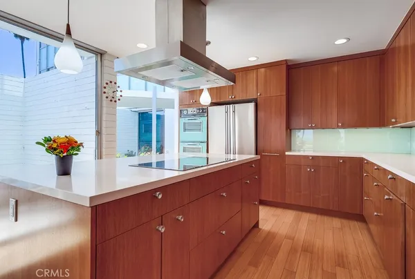 a kitchen with stainless steel appliances granite countertop a coffee maker a sink and a refrigerator