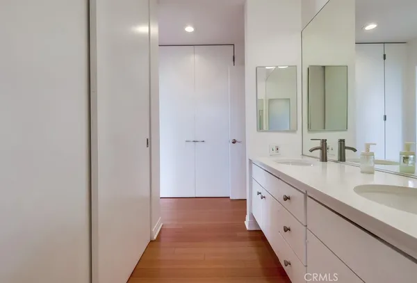 a bathroom with a double vanity sink mirror and toilet