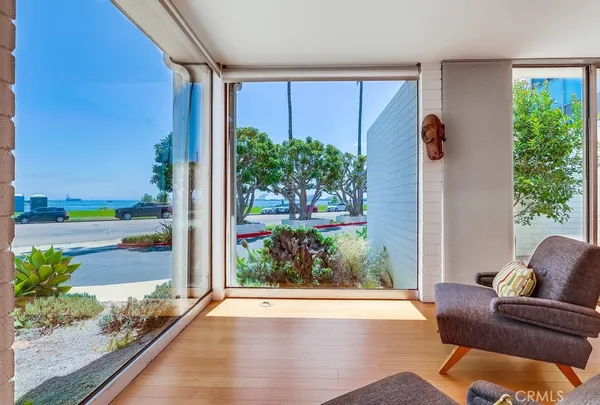 a large kitchen with stainless steel appliances a large counter top a refrigerator and a ocean view