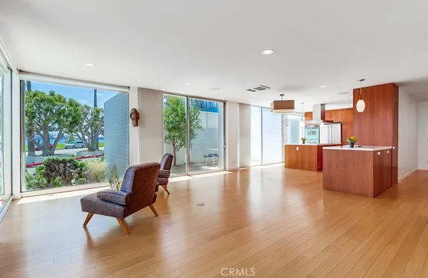 a large kitchen with stainless steel appliances granite countertop a large counter top a stove and a wooden floors