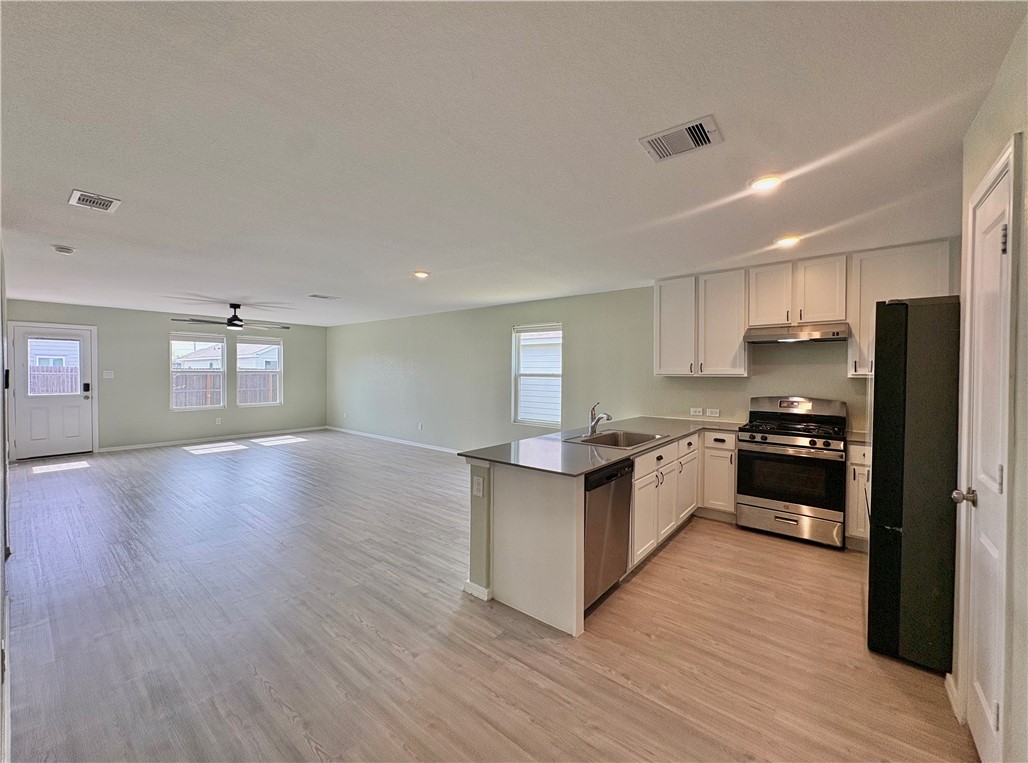 1109 Demeter Drive Portland, TX 78374 - Photo 3 of 18 a large kitchen with a center island and wooden floor