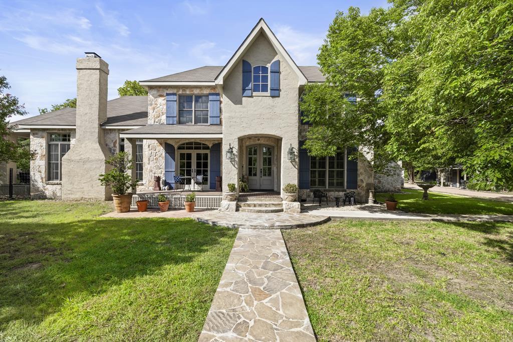 3965 Highway 27 Kerrville, TX 78028 - Photo 1 of 62 a front view of a house with swimming pool having outdoor seating