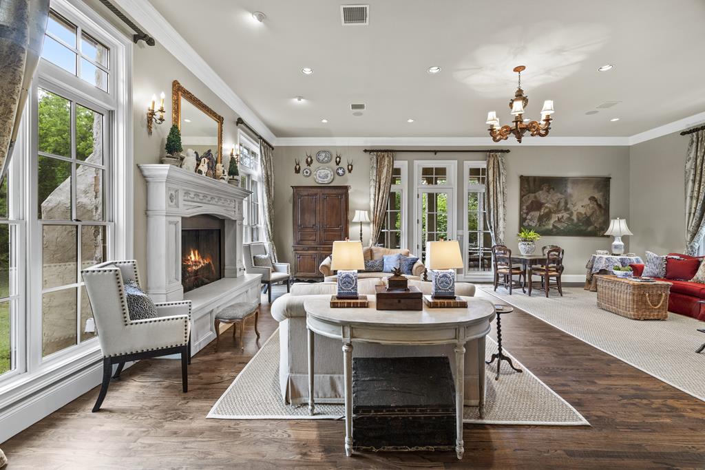3965 Highway 27 Kerrville, TX 78028 - Photo 14 of 62 a living room with furniture a fireplace and a chandelier
