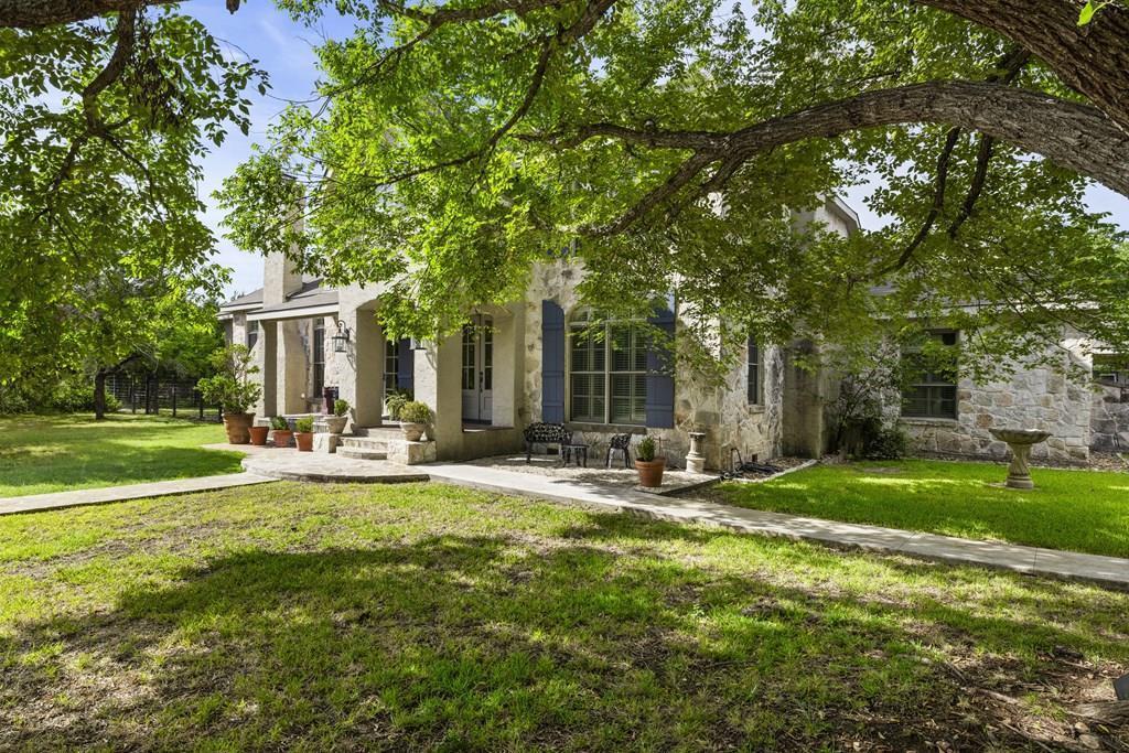 3965 Highway 27 Kerrville, TX 78028 - Photo 2 of 62 a view of a house with backyard and sitting area