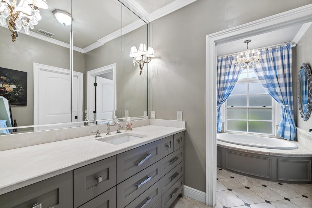3965 Highway 27 Kerrville, TX 78028 - Photo 23 of 62 a bathroom with a double vanity sink and a mirror