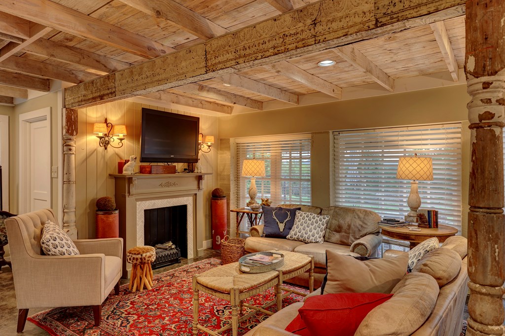 3965 Highway 27 Kerrville, TX 78028 - Photo 50 of 62 a living room with furniture a fireplace and a flat screen tv