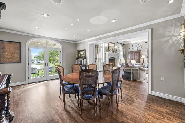 a living room with fireplace furniture and a large window