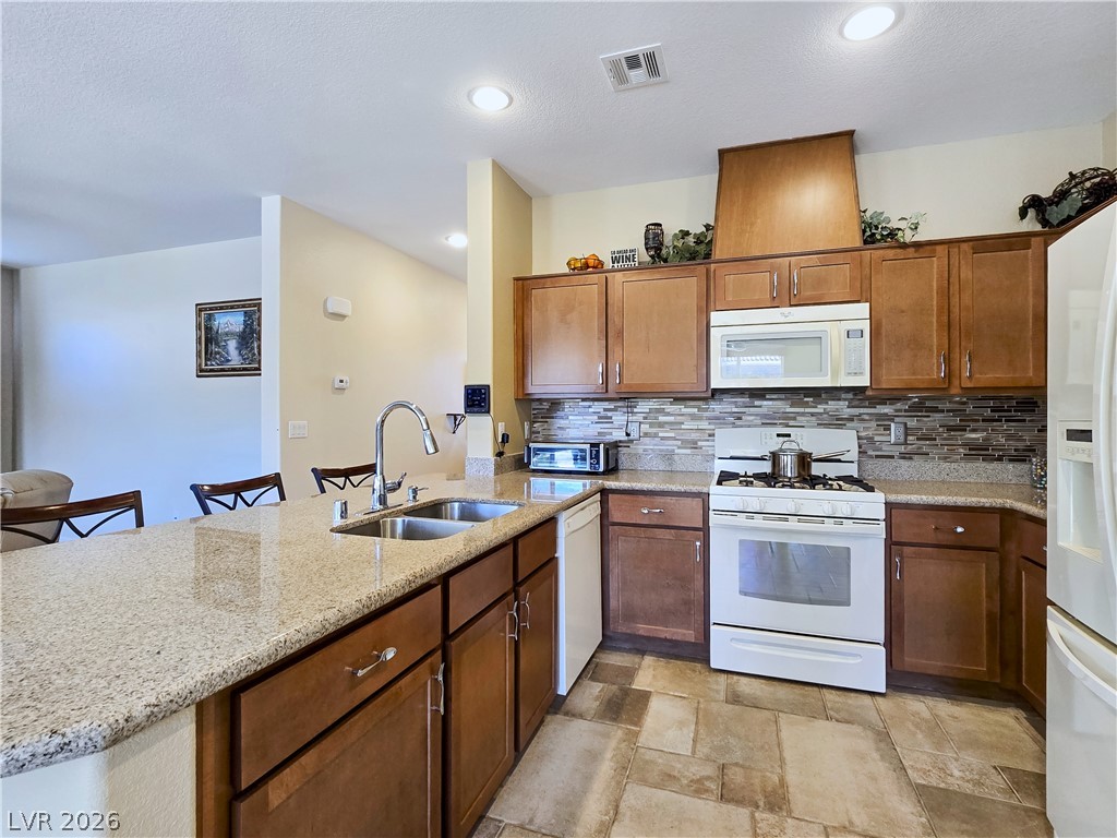 2485 Morrow Ridge Place Laughlin, NV 89029 - Photo 15 of 40 A well-appointed kitchen features ample counter space, rich wood cabinetry, and a full suite of appliances.