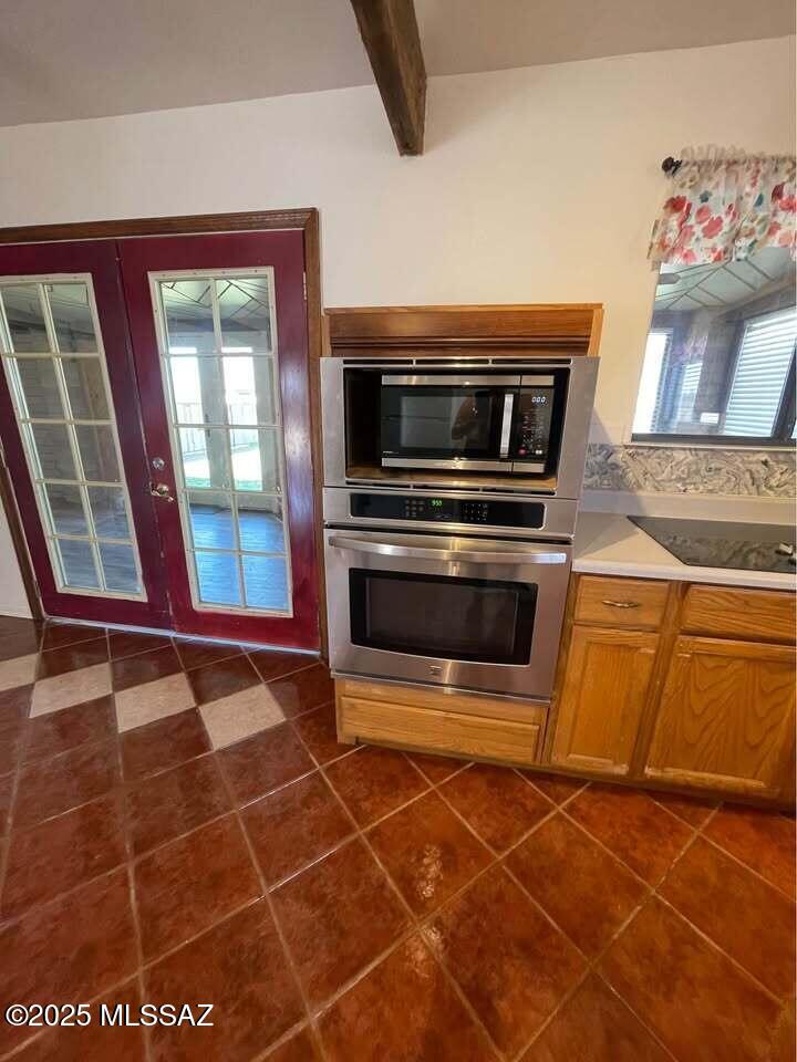 1094 North Pomerene Road Benson, AZ 85602 - Photo 18 of 48 a kitchen with granite countertop a stove and a microwave