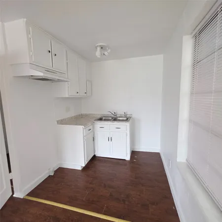 a room with a white cabinets and a sink