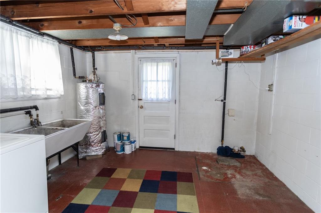 117 Cemetery Road Vanderbilt, PA 15486 - Photo 25 of 25 a room with a black white checkered floor with a rug and a window