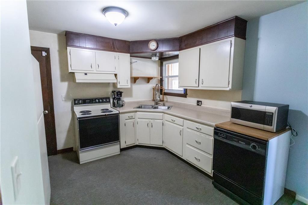 117 Cemetery Road Vanderbilt, PA 15486 - Photo 9 of 25 a kitchen with white cabinets and white appliances