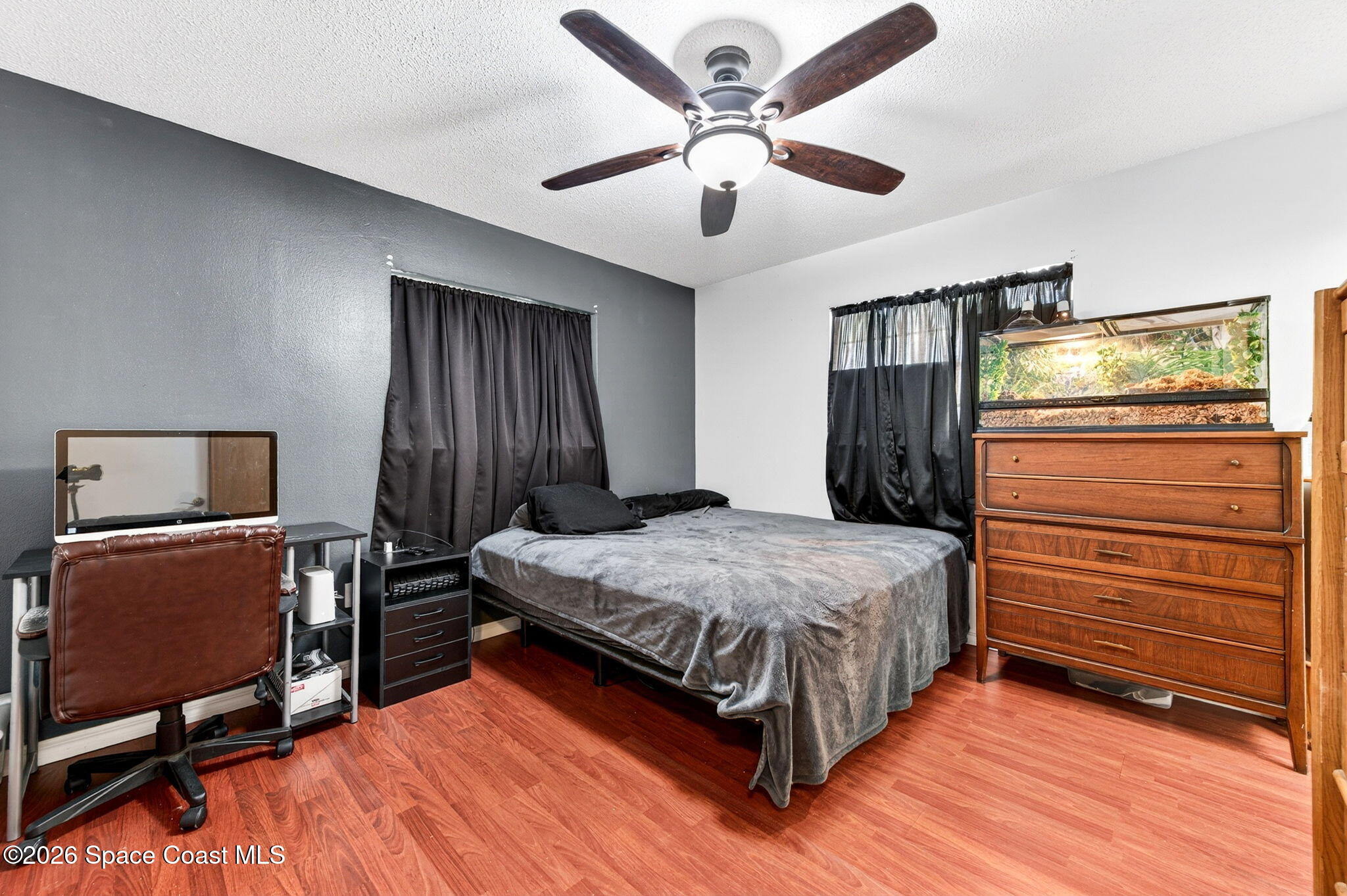 3300 Argyle Road Titusville, FL 32796 - Photo 19 of 29 a bedroom with a bed and a flat tv screen on dresser