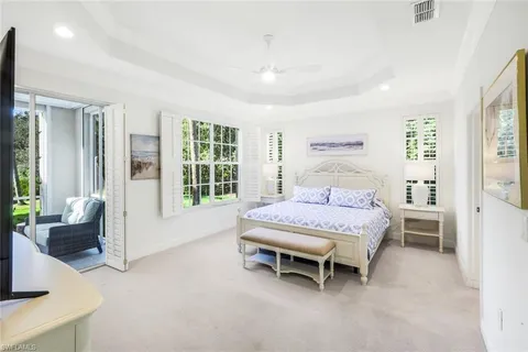 a bedroom with a bed and large window