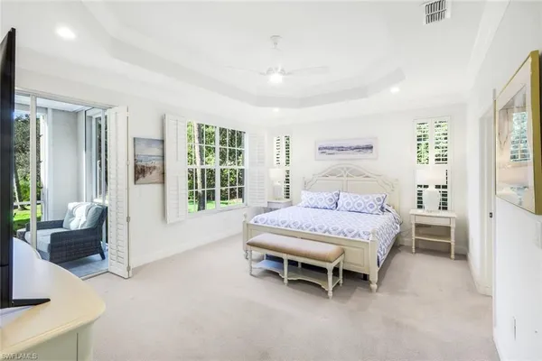 a bedroom with a bed and large window