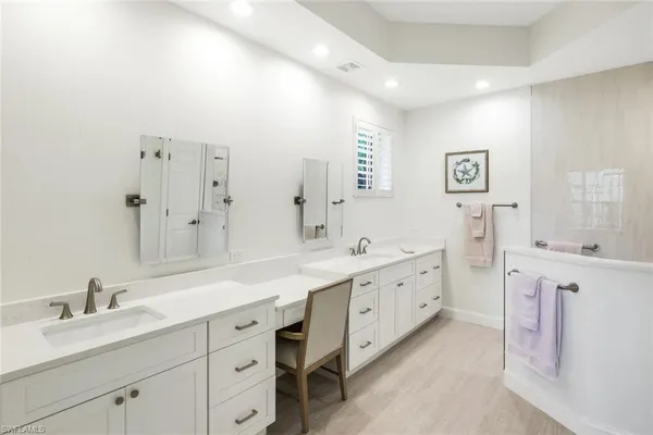 a bathroom with a tub sink and shower