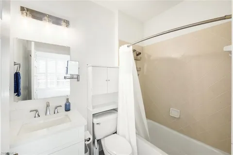 a living room with furniture a window and a flat screen tv