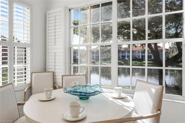 a dining room with furniture windows and wooden floor